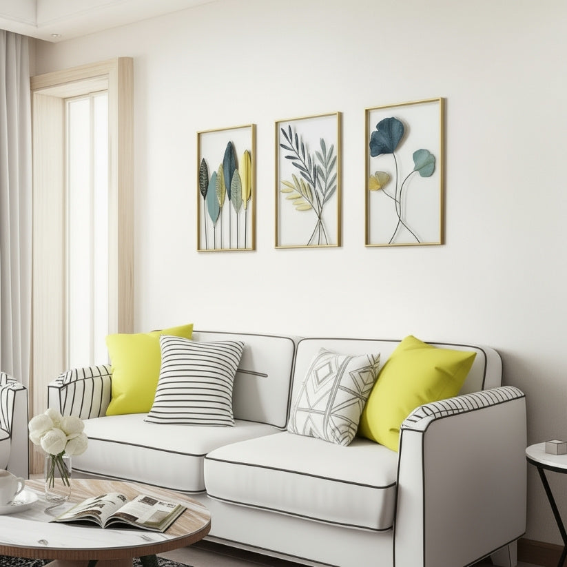 Modern living room with a gray sofa, yellow and patterned cushions, and framed botanical art on the wall.