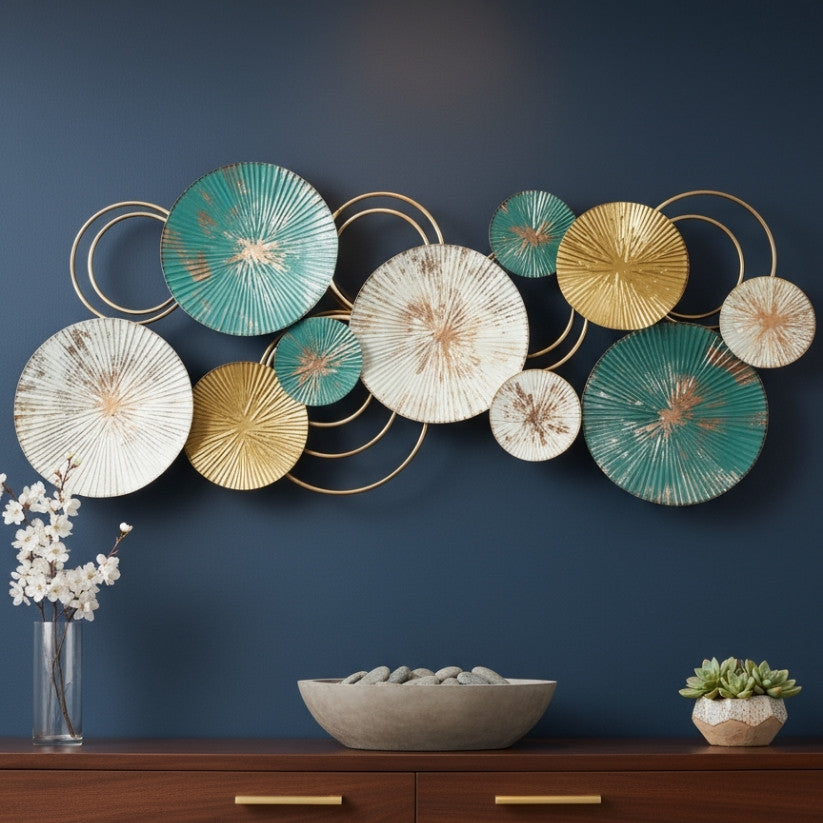 Decorative wall art with circular plates in gold, green, and white on a dark blue wall.