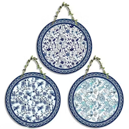 Set of three decorative plates with blue and white floral patterns on a white background